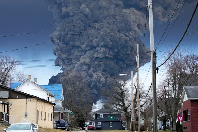 FILE – A black plume rises over East Palestine, Ohio, as a result of a controlled detonation of a portion of the derailed Norfolk Southern trains, Feb. 6, 2023. Norfolk Southern announced new details Monday, Sept. 18, about its plan to compensate East Palestine residents for lost home values since the fiery derailment disrupted life…