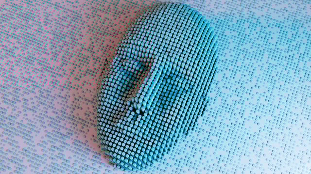 A face emerging from a sea of data.