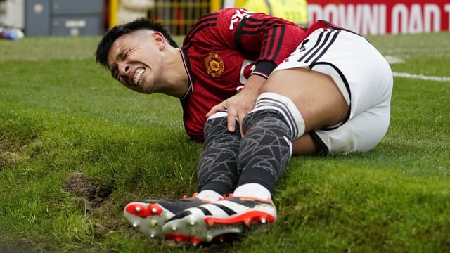 Manchester United's Lisandro Martinez grimaces in pain after an injury during the English Premier League soccer match between Manchester United and West Ham United at the Old Trafford stadium in Manchester, England, Sunday, Feb. 4, 2024. (AP Photo/Dave Thompson)