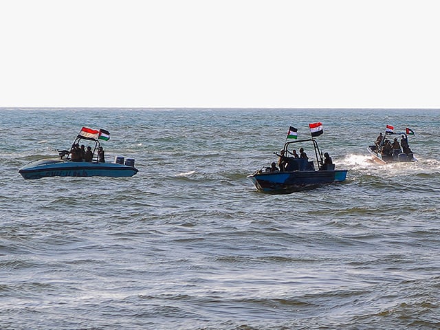 Members of the Yemeni Coast Guard affiliated with the Houthi group patrol the sea as demonstrators march through the Red Sea port city of Hodeida in solidarity with the people of Gaza on January 4, 2024, amid the ongoing battles between Israel and the militant Hamas group in Gaza. (Photo by AFP via Getty Images)
