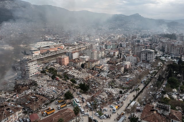 Smoke billows from the scene of collapsed buildings on February 7, 2023 in Hatay, Turkey.