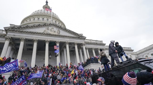 FILE – Rioters loyal to President Donald Trump stand on vehicles and the steps of the U.S. Capitol on Jan. 6, 2021, in Washington. Jason Donner, a former Fox News producer says in a lawsuit filed Monday, Nov. 13, 2023, he was targeted and fired for pushing back against false claims about the riot at the U.S. Capitol on Jan. 6. Donner said he was part of a “purge” of employees who refused to report information that would please Trump and his supporters. Donner was inside the Capitol during the riot and pressed his complaints about the networks coverage for months(AP Photo/Julio Cortez, File)