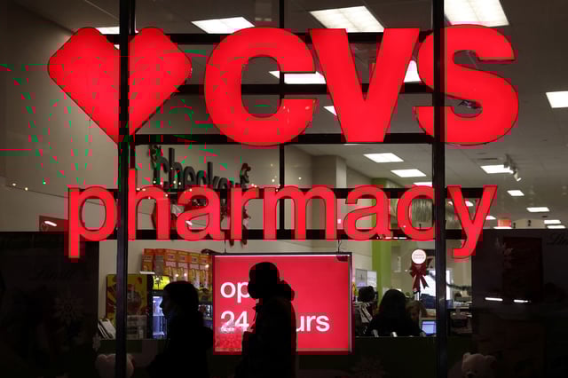 People walk by a CVS pharmacy store in Manhattan, New York, on November 17, 2021.