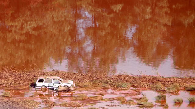 An aerial photo taken on October 8, 2010 shows a car amid a toxic red mud spill, a few kilometers from the village of Kolontar, Hungary.