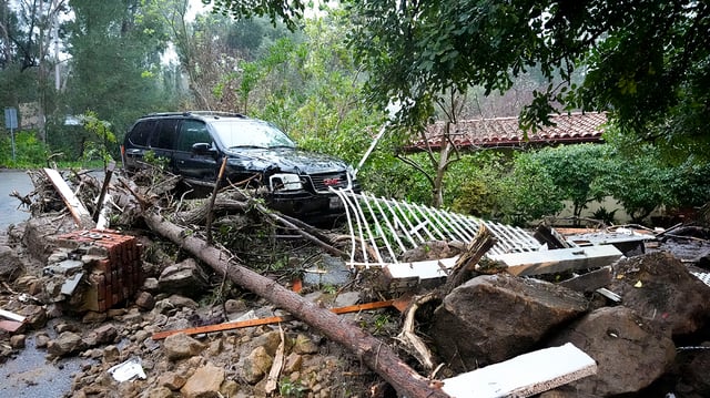 Mud, rocks and debris from a storm are strewn outside of a property Monday, Feb. 5, 2024, in Studio City, Calif. The second of back-to-back atmospheric rivers took aim at Southern California, unleashing mudslides, flooding roadways and knocking out power as the soggy state braced for another day of heavy rains. (AP Photo/Marcio Jose Sanchez)