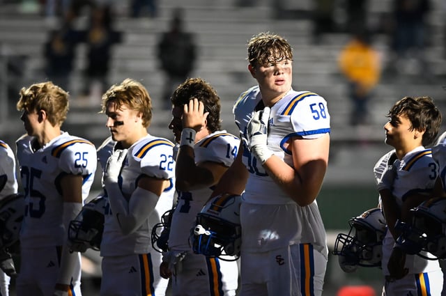Catholic Memorial offensive tackle Owen Strebig (58) and teammates participate in pregame ceremonies before the game against Pius XI on Friday, September 29, 2023, at Raabe Stadium in Wauwatosa, Wisconsin.