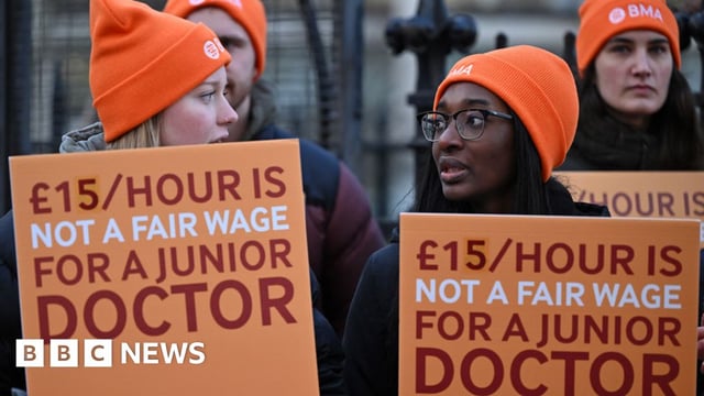 People hold placards during the junior doctors strike in January