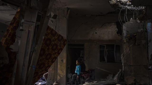 A Palestinian child looks at the damage to his family's house after an Israeli strike in Rafah, southern Gaza Strip, Thursday, Feb. 8, 2024. (AP Photo/Fatima Shbair)