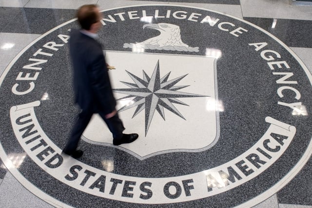 A man crosses the Central Intelligence Agency seal in the lobby of CIA Headquarters in Langley, Va., on Aug. 14, 2008.