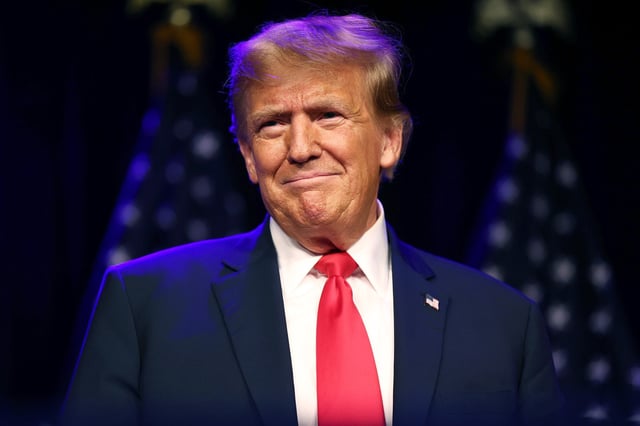 Former President Donald Trump greets supporters during his caucus night watch party at the Treasure Island Hotel & Casino, in Las Vegas, on Feb. 8, 2024.