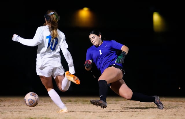 Perry goalie Trinity Lujan (1) comes in for a diving save against Xavier Prep midfielder Liv Yu (10) during a game at Perry High School in Gilbert on Jan. 25, 2024.