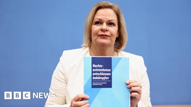 Nancy Faeser holding a copy of the plan