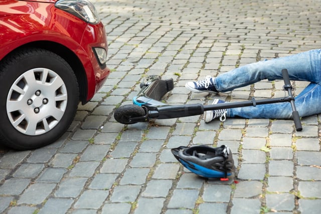 Man After Accident On Electric Scooter Overrun By Car (© Andrey Popov - stock.adobe.com)