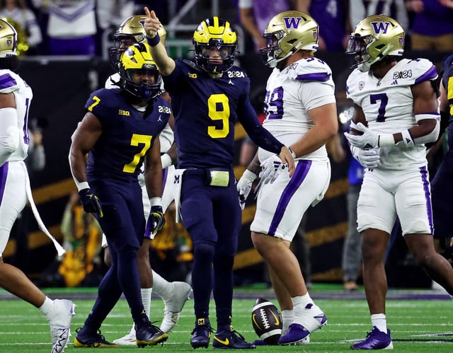 Michigan quarterback J.J. McCarthy celebrates after a first down during the third quarter against Washington in the College Football Playoff national championship game at NRG Stadium.