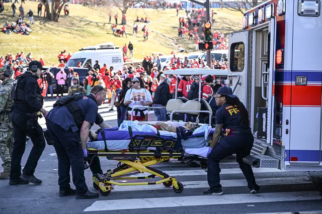 An injured person is loaded on an ambulance near the Kansas City Chiefs' Super Bowl LVIII victory parade on Feb. 14, 2024, in Kansas City, Mo.