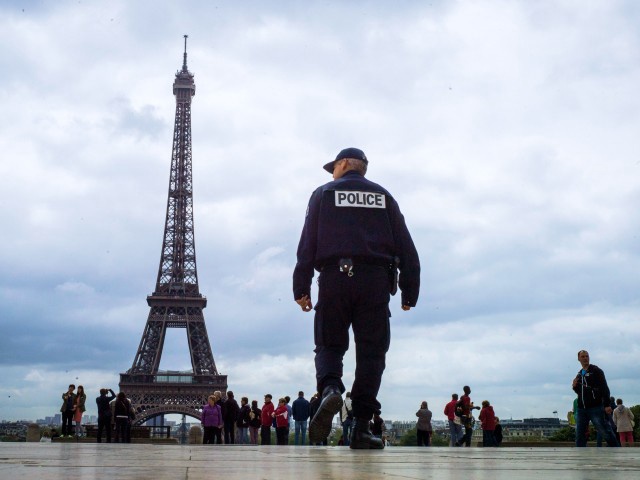 (FILES) In this photograph taken on May 14, 2013, a policeman patrols on Trocadero Square in front of the Eiffel Tower in Paris. / AFP PHOTO / FRED DUFOUR (Photo credit should read FRED DUFOUR/AFP via Getty Images)