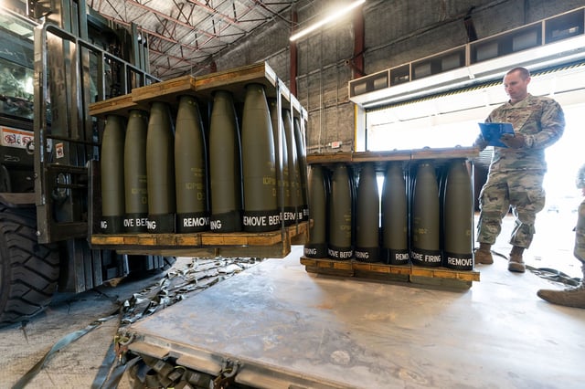 In this April 2022 photo, US Air Force Staff Sgt. Cody Brown, right, with the 436th Aerial Port Squadron, checks pallets of 155 mm shells ultimately bound for Ukraine at Dover Air Force Base in Delaware.