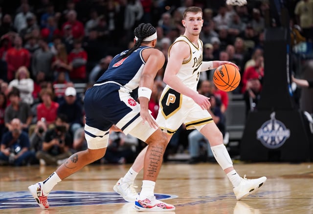 Purdue guard Braden Smith (3) dribbles against Arizona guard Kylan Boswell (4) during the second half at Gainbridge Fieldhouse.