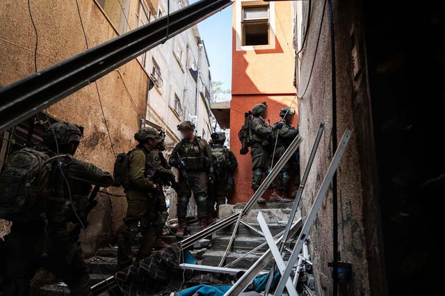 An image released by the Israeli Army on Feb. 20, 2024 shows soldiers raiding a building at an undisclosed location in the Gaza Strip. 