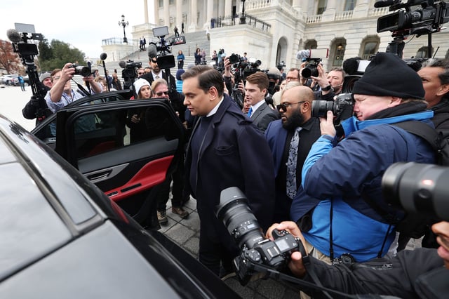 Rep. George Santos is surrounded by journalists as he leaves the US Capitol after his fellow members of Congress voted to expel him from the House of Representatives on December 1, 2023, in Washington, DC.