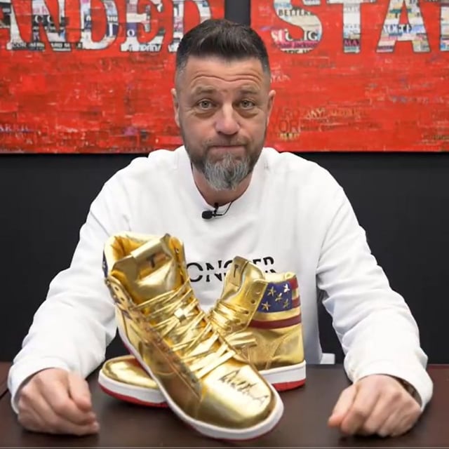 A screenshot of Roman Sharf, the founder and CEO of luxury watch dealer, Luxury Bazaar, talking in a video he uploaded to social media. In it, he responded to those who have slammed him for spending $9,000 on a pair of Donald Trump sneakers.