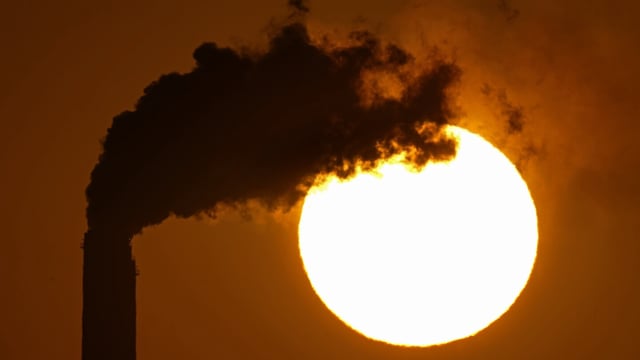 FILE - Emissions rise from the smokestacks at the Jeffrey Energy Center coal power plant as the suns sets Sept. 18, 2021, near Emmett, Kan. The Biden administration is setting tougher standards for deadly soot pollution, saying that reducing fine particle matter from tailpipes, smokestacks and other industrial sources could prevent thousands of premature deaths a year. (AP Photo/Charlie Riedel, File)