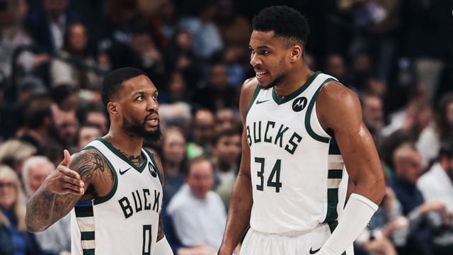 Damian Lillard (left) and Giannis Antetokounmpo (right) communicating on the floor.