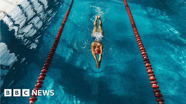 A woman swimming in a pool lane