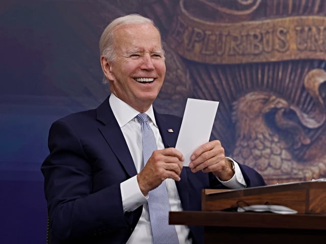 WASHINGTON, DC - JULY 28: U.S. President Joe Biden reads a note from an aide saying that the Creating Helpful Incentives to Produce Semiconductors (CHIPS) for America Act had received enough yes votes in the House of Representatives to pass during a meeting in the South Court Auditorium of the White House on July 28, 2022 in Washington, DC. President Biden held the meeting on the U.S. Economy with CEOs and members of his Cabinet. (Photo by Anna Moneymaker/Getty Images)