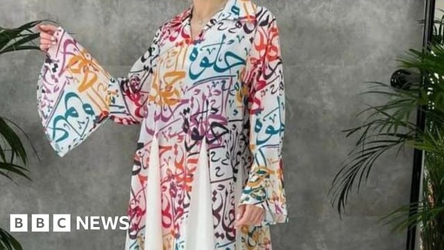 The dress has the word "Halwa" printed in Arabic letters on it, meaning sweet in Arabic