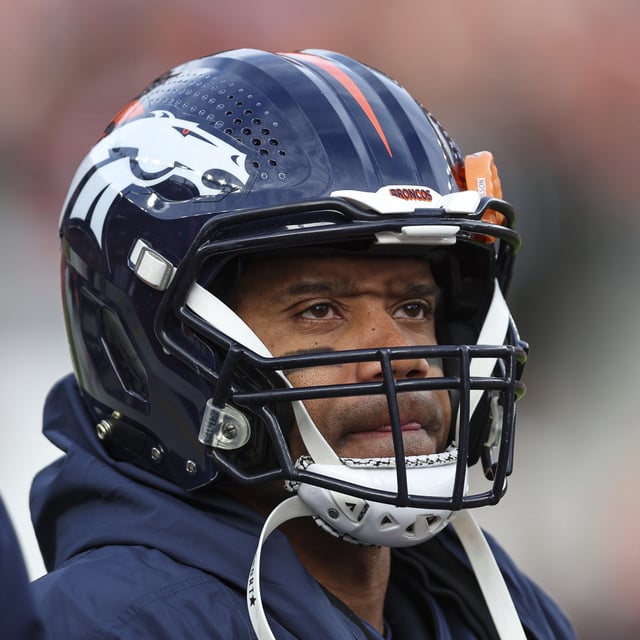Russell Wilson #3 of the Denver Broncos looks on from the sideline during an NFL football game against the Los Angeles Chargers at Empower Field at Mile High on December 31, 2023 in Denver, Colorado. The quarterback made headlines by saying he'd like to win two more titles.