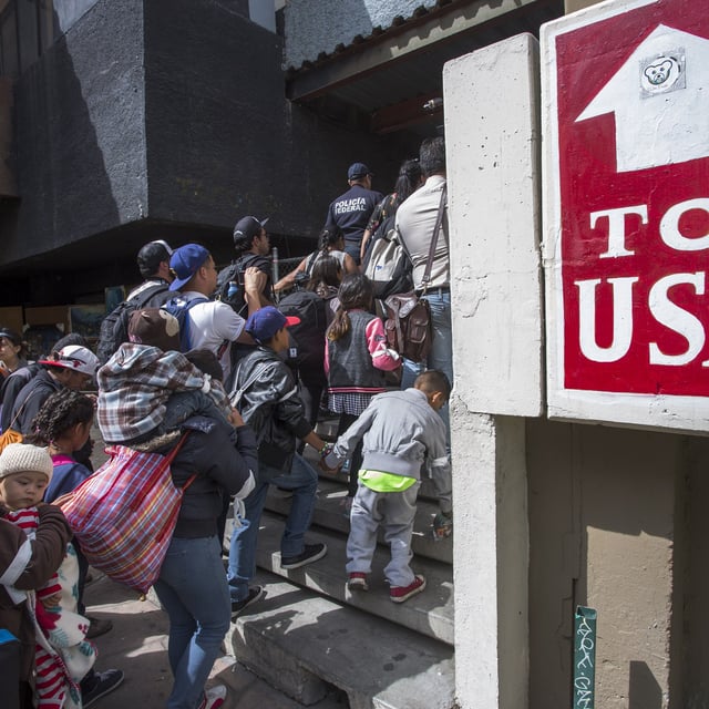 Members of a caravan of Central Americans who spent weeks traveling across Mexico walk from Mexico to the U.S. side of the border to ask authorities for asylum on April 29, 2018 in Tijuana, Baja California Norte, Mexico. A Gallup poll released February 27, 2024, finds that more Americans currently view illegal immigration as a "critical threat" than did in 2004.