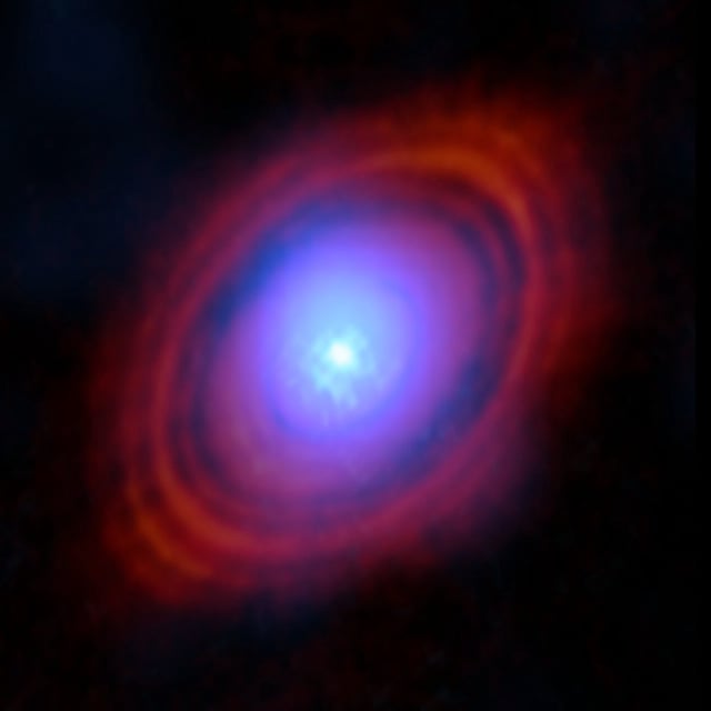 Astronomers have found water vapour in a disc around a young star exactly where planets may be forming. In this image, the new observations from the Atacama Large Millimeter/submillimeter Array (ALMA),  show the water vapour in shades of blue. The red-hued rings are previous ALMA observations showing the distribution of dust around the star.