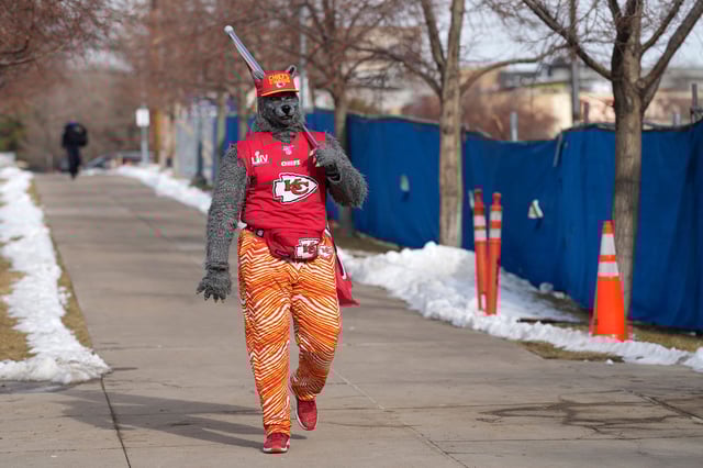 A Kansas City Chiefs fan, Chiefsaholic, walks toward Empower Field at Mile High before an NFL football game between the Denver Broncos and the Chiefs Saturday, Jan. 8, 2022, in Denver.