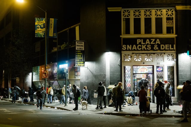 People wander through an unofficial night market on the corner of Charles J. Brenham Place and McAllister Street in San Francisco on Thursday, Feb. 15, 2024. There are children in U.N. Plaza in San Francisco in the evening hours selling drugs and according to the City, and there have been over 50 kids that have been taken in custody due to the illicit activity.