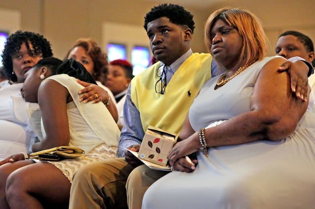 Relatives of Jocelyn Peters mourn during her funeral, at the Journey Church in Kirkwood, Mo. on March 30, 2016.
