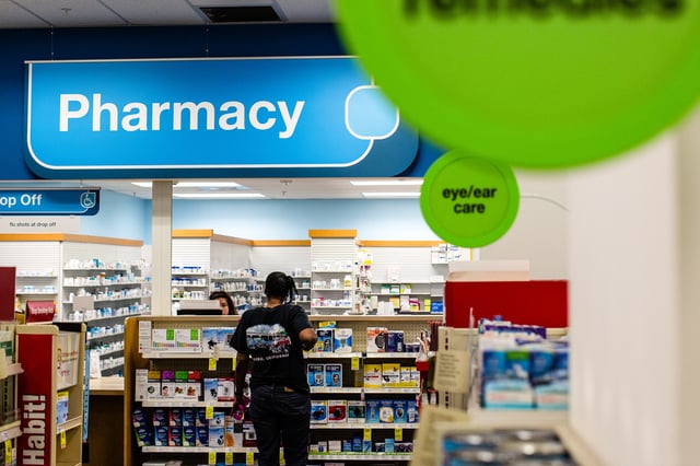 A pharmacist assists a customer at a CVS Health store in downtown Los Angeles on Oct. 27, 2017.
