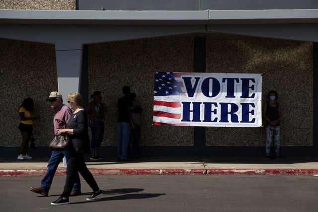 Voters leave the Dr. Pattie Dodson Public Health Center, one of the polling locations in Victoria, Texas, on the first day of early voting on Tuesday, Oct. 13, 2020.