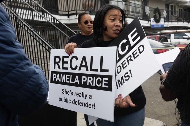 Patricia Harris arrives with signs at a recall drive calling on the removal of Alameda County District Attorney Pamela Price in Oakland on Sunday, Oct. 15, 2023. Her son, Jarin Purvis, was killed by a gunshot.