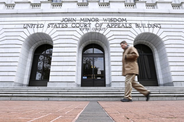 A man walks in front of the 5th U.S. Circuit Court of Appeals, Jan. 7, 2015, in New Orleans.