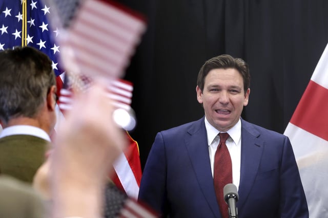 Florida Gov. Ron DeSantis gets a cheering welcome during a press conference at the Central Florida Tourism Oversight District headquarters at Walt Disney World, in Lake Buena Vista, Fla., Thursday, Feb. 22, 2024. Almost a year after Florida lawmakers passed a law giving Florida’s governor control over Walt Disney World’s governing district, DeSantis on Thursday called the takeover a success, despite an exodus of workers, ongoing litigation and scandal surrounding one of his appointees. (Joe Burbank/Orlando Sentinel via AP)