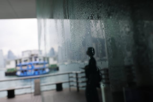 People pass by Tsim Sha Tsui Waterfront. Internet users shared pictures showing water droplets forming on the surfaces of ceilings and walls. Photo: Jelly Tse