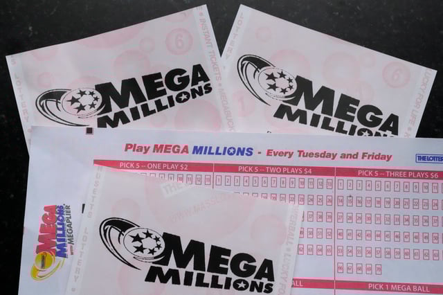 Mega Millions lottery tickets and a wager slip are displayed, Friday, Jan. 6, 2023.