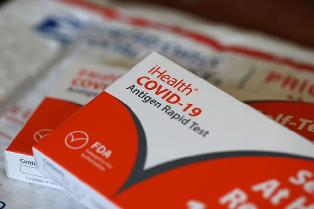 SAN ANSELMO, CALIFORNIA - FEBRUARY 04: In this photo illustration, free iHealth COVID-19 antigen rapid tests from the federal government sit on a U.S. Postal Service envelope after being delivered on February 04, 2022 in San Anselmo, California. The Biden administration has secured one billion at home COVID-19 tests and will deliver four per household for free to anyone who requests them. The tests can be ordered on the U.S. Postal Service website and will arrive 7-14 days after.  (Photo Illustration by Justin Sullivan/Getty Images)