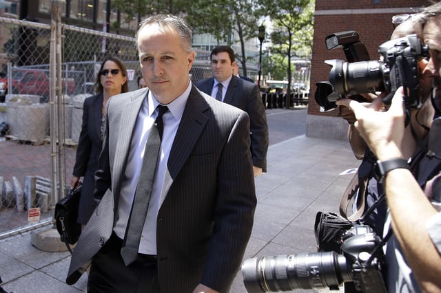 FILE - In this June 26, 2017, file photo, Barry Cadden, president of the New England Compounding Center, followed by members of his legal team, arrives at the federal courthouse for his sentencing in Boston. Cadden, founder of a now-defunct Massachusetts pharmaceutical facility responsible for a deadly meningitis outbreak, will spend 14 and a half years behind bars, a federal judge ruled Wednesday, July 7, 2021, lengthening his initial punishment of nine years that was tossed out by an appeals court. (AP Photo/Stephan Savoia, File)