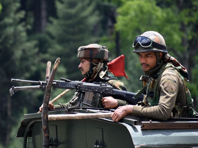 KASHMIR, INDIA-JUNE 17: Indian army soldiers on top of a military vehicle move along the Srinagar-Leh National highway on June 17, 2020.At least 20 Indian soldiers were killed in a violent clash with Chinese forces in a disputed border area. (Photo by Faisal Khan/Anadolu Agency via Getty Images)