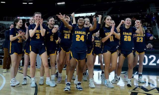 Eagles guard Janaya Prince Baquero (24) help lead the Barrington Eagles girls basketball team call out to acknowledge their fans and supporters after winning the Div 1 Girls Basketball Championship against North Kingstown Skippers at the AMP on March 6, 2024.