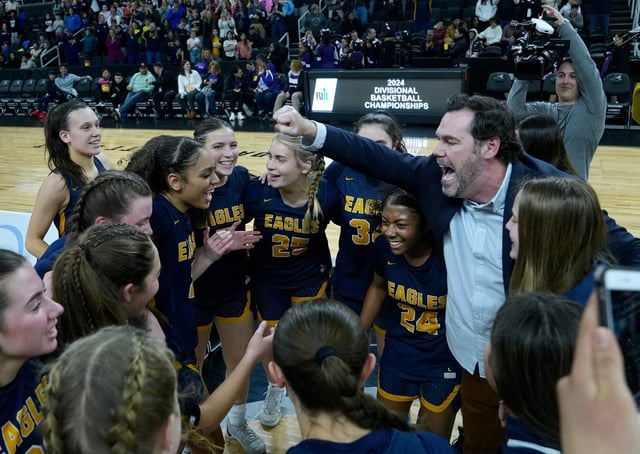 Barrington Eagles coach Stephen Lenz celebrates with the team after winning the Div 1 Girls Basketball Championship against the North Kingstown Skippers at the AMP on March 6, 2024.