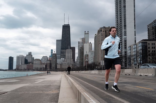 CHICAGO, ILLINOIS - FEBRUARY 08: A jogger runs along Lake Michigan as temperature climbed to near 60 degrees, more than 20 degrees above normal on February 08, 2024 in Chicago, Illinois. The warmer-than-usual day came on the same day that Scientists announced the world surpassed a key warming threshold across an entire year for the first time on record. (Photo by Scott Olson/Getty Images)