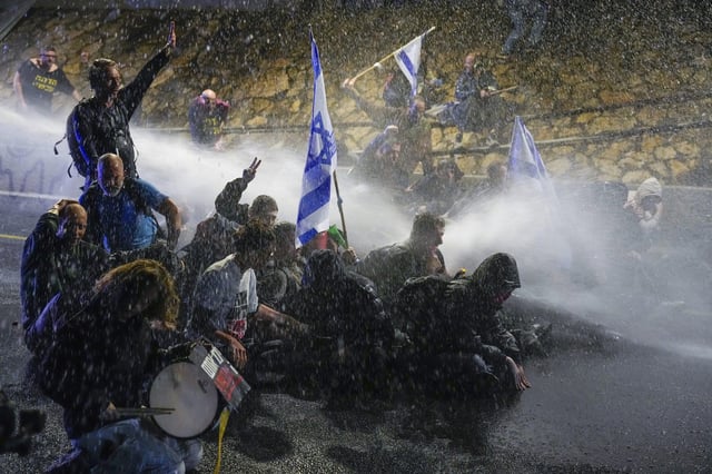 Police use water cannons to disperse demonstrators during a protest against Israeli Prime Minister Benjamin Netanyahu’s government in Tel Aviv on Saturday. Photo: AP